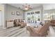 Bright living room with wicker furniture and sliding glass doors leading to a screened lanai with a pool at 7130 Scarlet Sage Ct, Punta Gorda, FL 33955