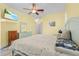 Spacious main bedroom with wood-look floors, a ceiling fan, and a serene, inviting ambiance at 7130 Scarlet Sage Ct, Punta Gorda, FL 33955