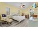 Bright main bedroom with a ceiling fan, wood-look floors, and access to a private lanai at 7130 Scarlet Sage Ct, Punta Gorda, FL 33955