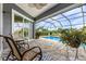 Relaxing screened patio with a ceiling fan overlooking the beautiful blue pool at 7130 Scarlet Sage Ct, Punta Gorda, FL 33955
