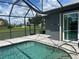 Screened-in pool with clear blue water, brick paver deck, and view of the surrounding neighborhood at 7130 Scarlet Sage Ct, Punta Gorda, FL 33955