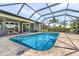 Sparkling pool surrounded by a paved deck and screened enclosure with plenty of space for lounge chairs at 7130 Scarlet Sage Ct, Punta Gorda, FL 33955