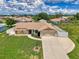 Home from above showcasing a well-kept lawn, driveway, and attached garage at 7218 Darlington St, Englewood, FL 34224