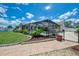 Backyard view featuring a screened-in pool, lush landscaping, and a paved patio for outdoor enjoyment at 7218 Darlington St, Englewood, FL 34224