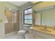 Bright bathroom featuring a shower, toilet and vanity with sink at 7218 Darlington St, Englewood, FL 34224
