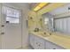 Bathroom featuring a shower, toilet and vanity with a large mirror at 7218 Darlington St, Englewood, FL 34224