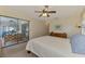 Well-lit bedroom with ceiling fan and sliding glass doors to outdoor seating at 7218 Darlington St, Englewood, FL 34224
