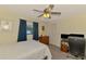 Comfortable bedroom with ceiling fan, closet and desk area with natural light at 7218 Darlington St, Englewood, FL 34224