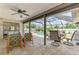 Enjoy the outdoor living space with a covered patio, comfortable seating, and access to the screened-in pool area at 7218 Darlington St, Englewood, FL 34224
