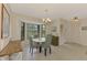 Charming dining area features a round table, bay window and a chandelier at 7218 Darlington St, Englewood, FL 34224