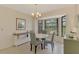 Charming dining area featuring a chandelier, bay window, and neutral décor at 7218 Darlington St, Englewood, FL 34224