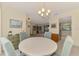 Bright dining room featuring a round table, comfortable seating, and a view to the kitchen at 7218 Darlington St, Englewood, FL 34224