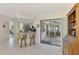 Open floor plan featuring a kitchen with breakfast bar, with view to the tiled sunroom and backyard at 7218 Darlington St, Englewood, FL 34224