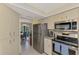 Well-lit kitchen featuring stainless steel appliances and sleek countertops, adjacent to a cozy dining area at 7218 Darlington St, Englewood, FL 34224