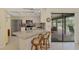 Modern kitchen featuring a breakfast bar, stainless steel appliances, and seamless access to the outdoor patio at 7218 Darlington St, Englewood, FL 34224