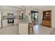 Bright kitchen featuring stainless steel appliances, granite countertops, and breakfast bar seating area at 7218 Darlington St, Englewood, FL 34224