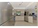 Updated kitchen boasts stainless steel appliances, granite countertops, and ample lighting, perfect for cooking at 7218 Darlington St, Englewood, FL 34224