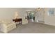 Cozy living room with plush armchairs and view into the dining area at 7218 Darlington St, Englewood, FL 34224