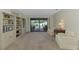 Bright living room with custom shelves and view of the screened in pool at 7218 Darlington St, Englewood, FL 34224