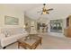 Comfortable living room with a large window, neutral carpet, and a view of the kitchen area at 7218 Darlington St, Englewood, FL 34224