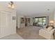 Open living room with a view of the screened in pool and built in shelving at 7218 Darlington St, Englewood, FL 34224