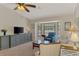 Inviting living room featuring a cozy seating area, a large bay window, and neutral décor at 7218 Darlington St, Englewood, FL 34224