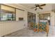 Relaxing screened patio with tile flooring, ceiling fan, and comfortable seating with views of the outdoors at 7218 Darlington St, Englewood, FL 34224
