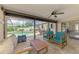 Inviting patio featuring tile floors, a ceiling fan, stylish seating, and views of the sparkling pool area at 7218 Darlington St, Englewood, FL 34224