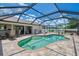 Enjoy the sunshine by the screened-in pool with ample seating, a grill, and a well-kept patio at 7218 Darlington St, Englewood, FL 34224