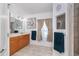 Bright bathroom with double sinks, wood cabinets, and neutral decor, ideal for a relaxing space at 7376 Stetson Ln, Port Charlotte, FL 33981