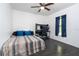 Cozy bedroom featuring a ceiling fan, dark floors, natural light, and a dedicated workspace at 7376 Stetson Ln, Port Charlotte, FL 33981