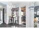 Cozy dining area with a small table, two chairs, and a view into a dining room with a ceiling fan at 7376 Stetson Ln, Port Charlotte, FL 33981