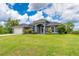 Beautiful home features mature landscaping, large lawn, attached garage, and striking curb appeal at 7376 Stetson Ln, Port Charlotte, FL 33981