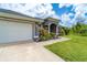 Charming home with well-manicured landscaping, a spacious driveway and an attached two-car garage at 7376 Stetson Ln, Port Charlotte, FL 33981