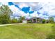 A charming single-story home featuring a manicured lawn, attached garage and a covered entrance, nestled under a sunny sky at 7376 Stetson Ln, Port Charlotte, FL 33981