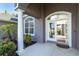 Welcoming front entrance with a well maintained garden, columns, an arched entryway and views into the house at 7376 Stetson Ln, Port Charlotte, FL 33981