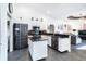 Modern kitchen features granite countertops, stainless steel appliances, and a breakfast bar with adjacent living area at 7376 Stetson Ln, Port Charlotte, FL 33981