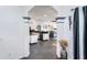 View of the living room through the arched opening to an adjacent kitchen featuring an island and stainless steel appliances at 7376 Stetson Ln, Port Charlotte, FL 33981