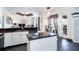 Bright kitchen with a center island, granite countertops, stainless steel appliances, and a view of the dining area at 7376 Stetson Ln, Port Charlotte, FL 33981