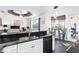 Open concept kitchen with black countertops, and a dining area with natural light streaming through large windows at 7376 Stetson Ln, Port Charlotte, FL 33981