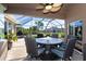 Covered patio with outdoor dining furniture, a ceiling fan, and scenic backyard views at 7376 Stetson Ln, Port Charlotte, FL 33981