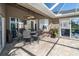 Charming covered patio with comfortable seating area and ceiling fan for outdoor relaxation at 7376 Stetson Ln, Port Charlotte, FL 33981