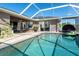 Inviting outdoor living with pool, lanai, and lush landscaping, perfect for entertaining at 7376 Stetson Ln, Port Charlotte, FL 33981