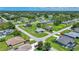 Aerial view of a sprawling residential area with mature trees and meticulously manicured lawns at 7437 Bass St, Englewood, FL 34224