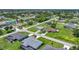 Neighborhood aerial showing a well-maintained street with green lawns and mature trees at 7437 Bass St, Englewood, FL 34224