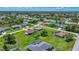 A serene neighborhood view from above showcasing well-kept homes, and tree coverage at 7437 Bass St, Englewood, FL 34224