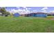 Expansive backyard featuring lush lawn and a storage shed at 7437 Bass St, Englewood, FL 34224