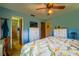 Cozy bedroom featuring a comfortable queen-sized bed with floral-patterned bedding and matching curtains at 7437 Bass St, Englewood, FL 34224