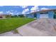 Charming single-story home with a well-maintained lawn, a driveway, and a welcoming entrance at 7437 Bass St, Englewood, FL 34224