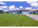 Charming single-story home with a well-manicured lawn and attached garage at 7437 Bass St, Englewood, FL 34224